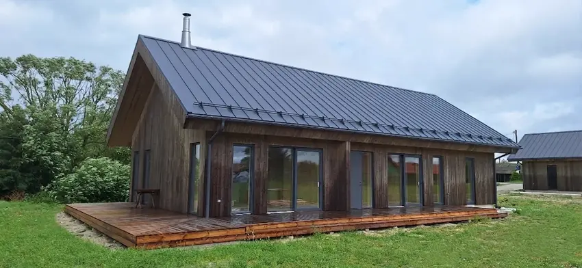 Completed timber house with dark timber cladding and a standing-seam roof