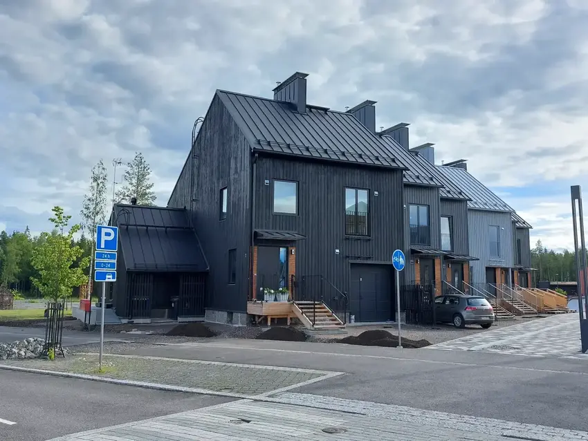 Completed black timber townhouses with standing-seam metal roofs