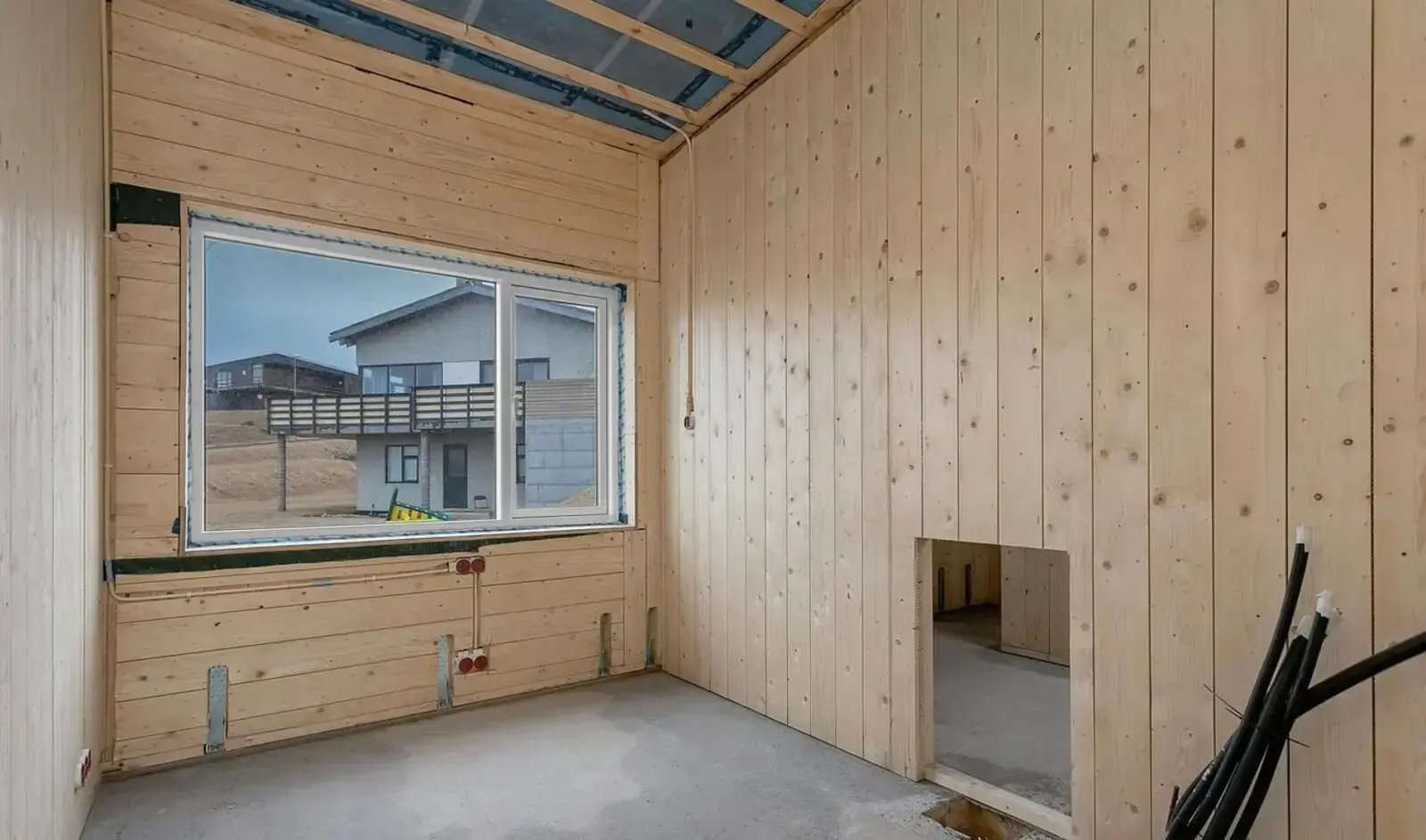 Exposed ceiling joists and a single large opening: the structure reads clearly long before any finishes go on.
